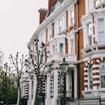 Victorian terraced houses with detailed facades on a quiet London street, exuding classic elegance.
